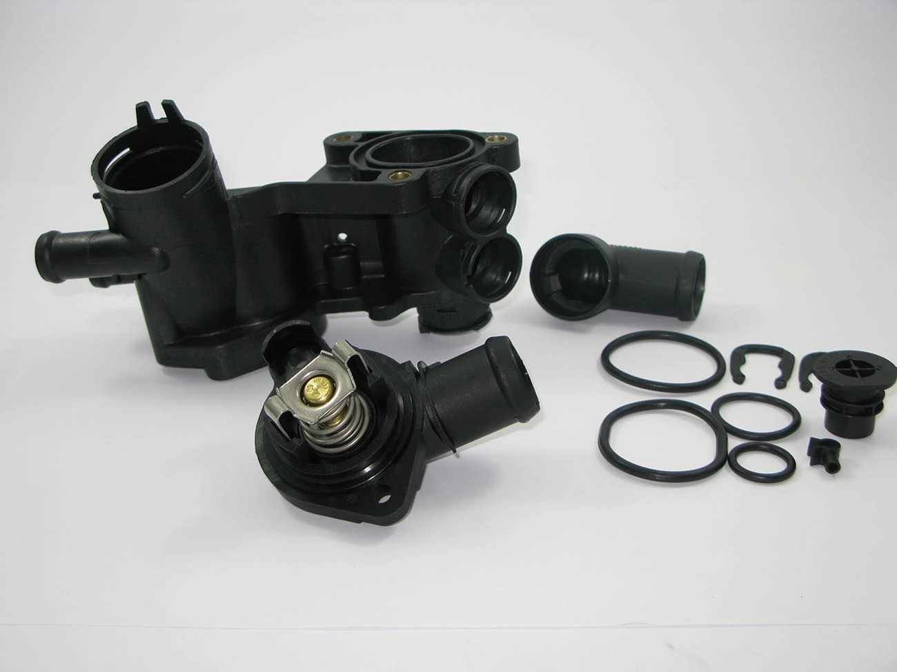 CARCAÇA/FLANGE PLÁSTICA COM VÁLVULA TERMOSTÁTICA CAVALETE ÁGUA VW GOL/VOYAGE/SAVEIRO 09/ FOX 03/ POLO 10/