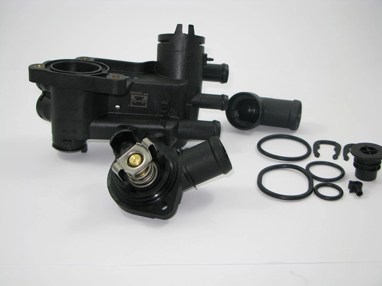 CARCAÇA/FLANGE PLÁSTICA COM VÁLVULA TERMOSTÁTICA CAVALETE ÁGUA VW GOL/VOYAGE/SAVEIRO 09/ FOX 03/ POLO 10/